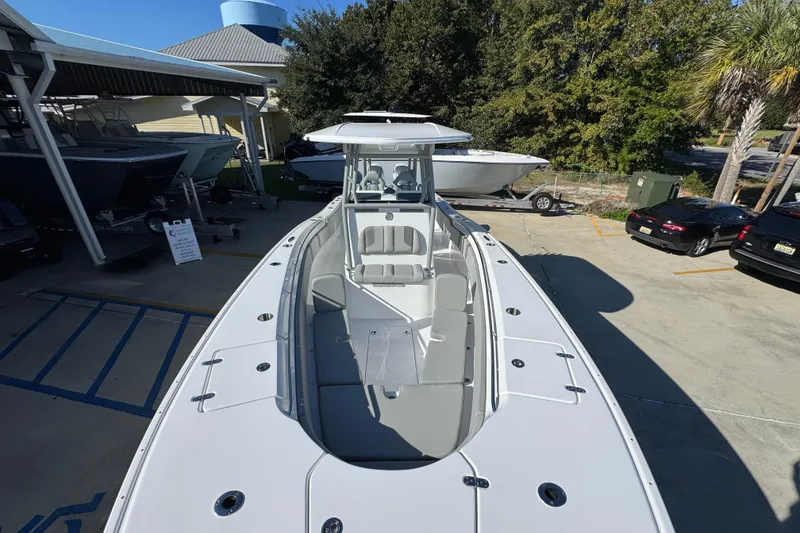 Slide: The Image of 2026 Cape Horn 32 XS boat displayed at a marina, showcasing sleek design and spacious deck. - 23