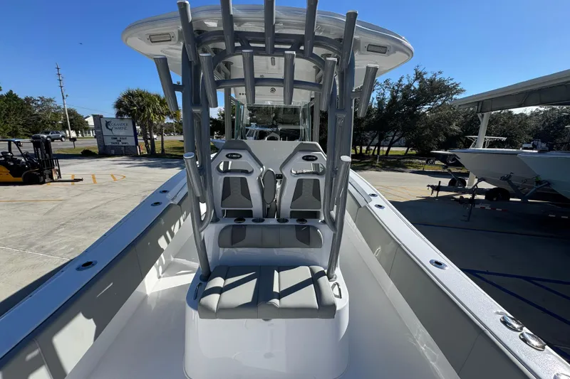Slide: The Image of 2026 Cape Horn 32 XS boat interior with seating and T-top under clear blue sky. - 36