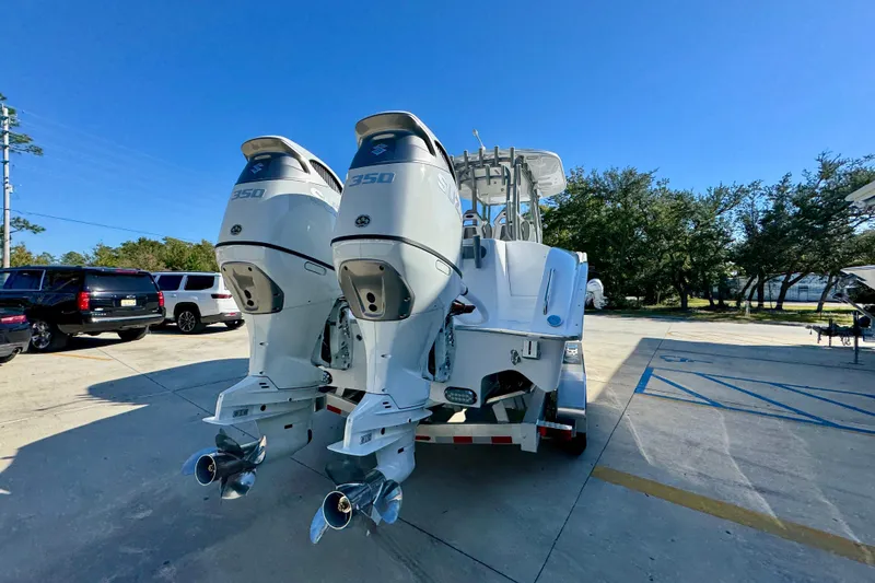 Slide: The Image of 2026 Cape Horn 32 XS boat with dual 350 horsepower engines in a parking lot. - 14
