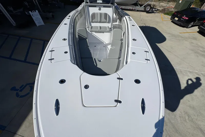 Slide: The Image of 2026 Cape Horn 32 XS boat with spacious deck and seating, parked outdoors. - 22