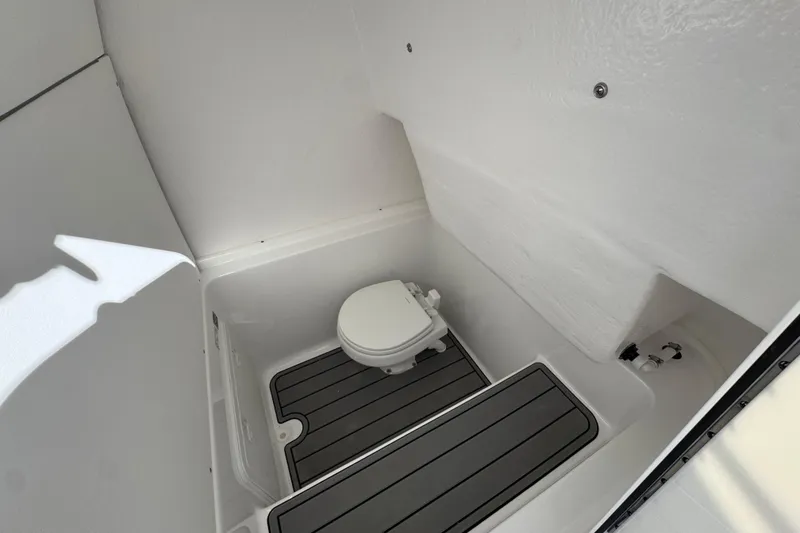 Slide: The Image of 2026 Cape Horn 32 XS boat interior with compact marine toilet and non-slip flooring. - 27
