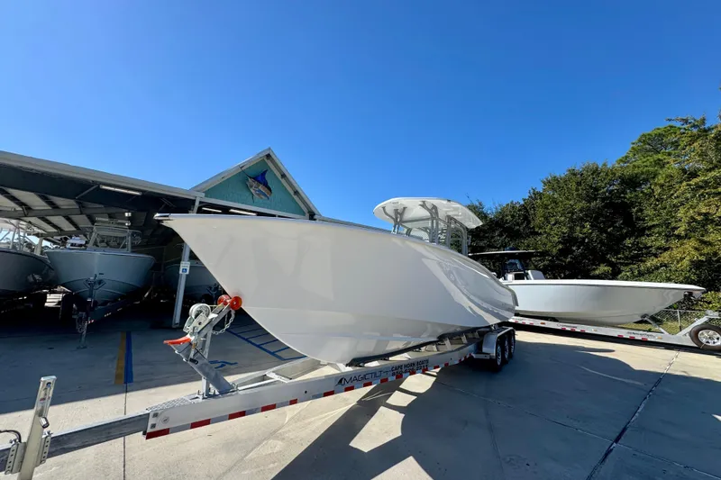 Slide: The Image of 2026 Cape Horn 32 XS boat on trailer under clear blue sky. - 4
