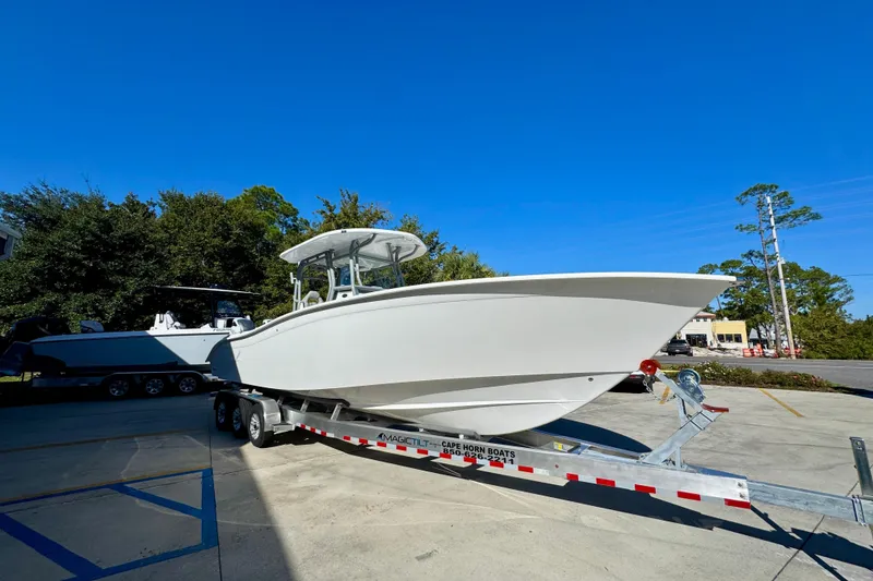 Slide: The Image of 2026 Cape Horn 32 XS boat on trailer under clear blue sky. - 8