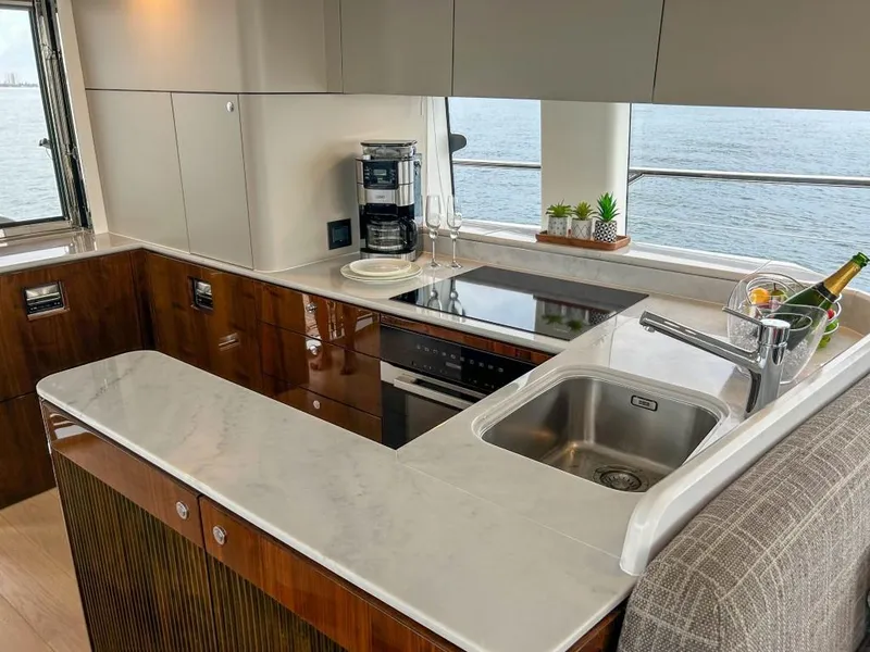 Slide: The Image of Modern kitchen on 2024 Fairline Squadron 68 yacht with ocean view. - 18