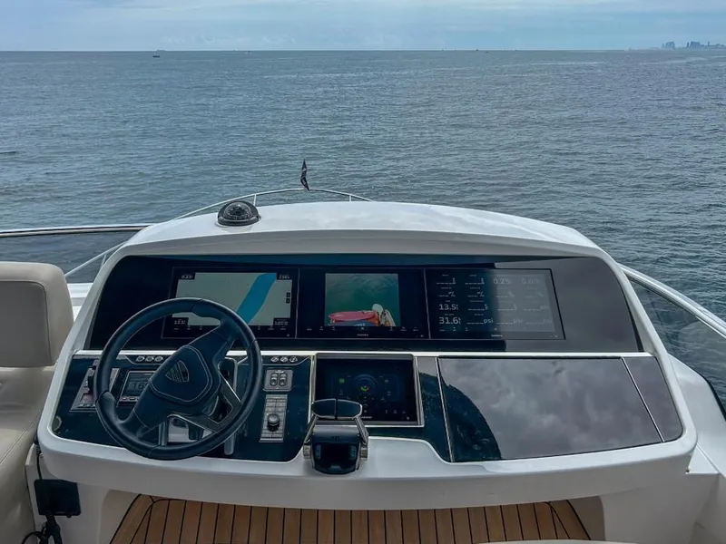 Slide: The Image of 2024 Fairline Squadron 68 yacht helm with advanced navigation system. - 38