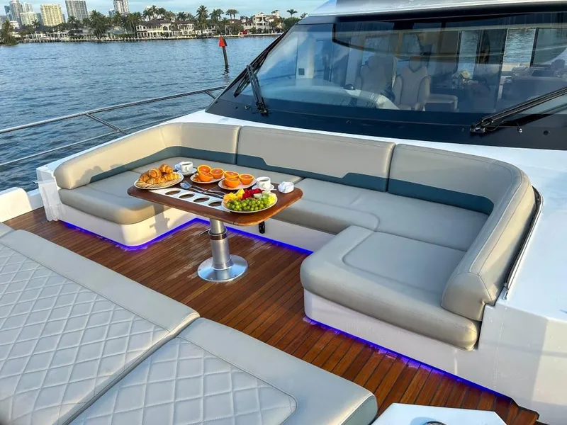 Slide: The Image of Luxurious 2024 Fairline Squadron 68 yacht with elegant outdoor seating and dining area. - 8