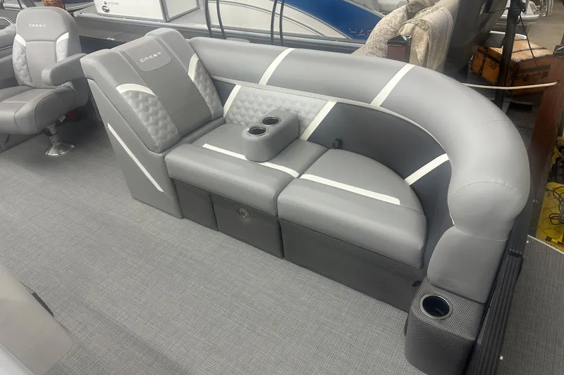 Slide: The Image of 2025 Crest Classic 220 boat interior with gray seating and cup holders. - 3