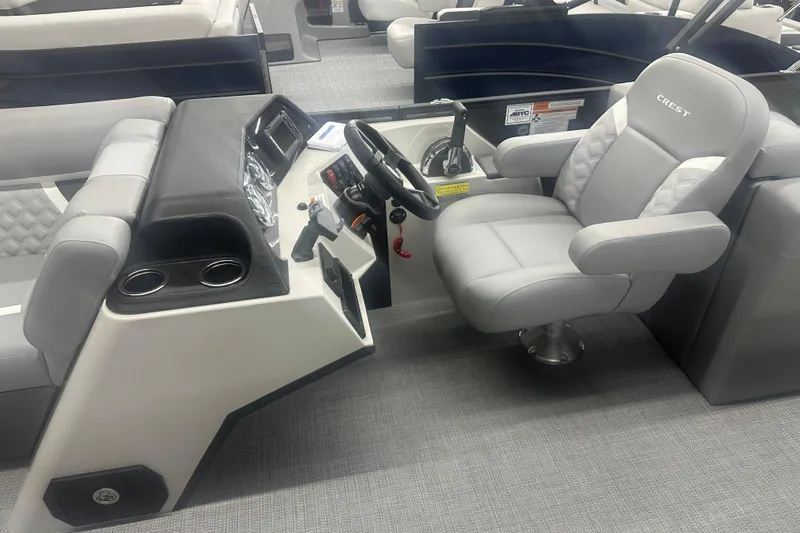 Slide: The Image of 2025 Crest Classic 220 boat interior with steering console and comfortable seating. - 6