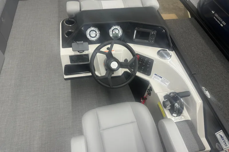 Slide: The Image of 2025 Crest Classic 220 boat dashboard with steering wheel and control panel. - 7
