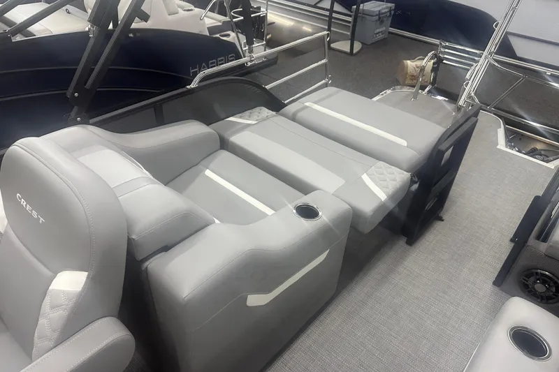 Slide: The Image of 2025 Crest Classic 220 boat interior with gray seating and cup holders. - 9