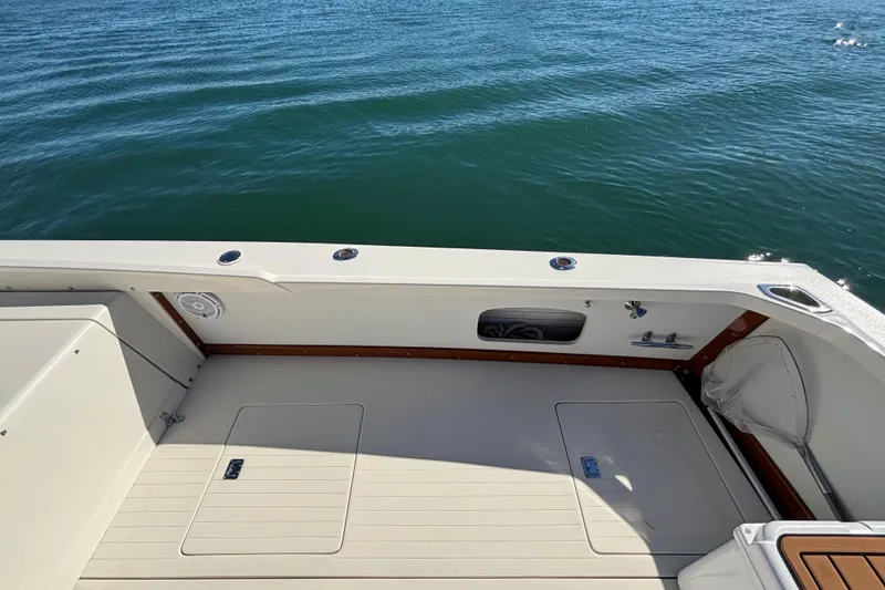 Slide: The Image of 1970 Bertram 31 Flybridge Cruiser deck overlooking calm blue water. - 26