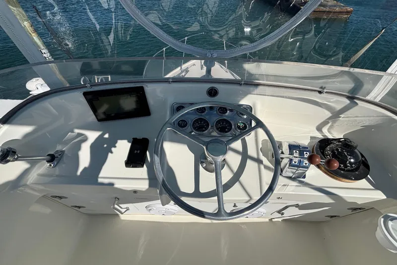 Slide: The Image of Helm of 1970 Bertram 31 Flybridge Cruiser with steering wheel and navigation instruments. - 31
