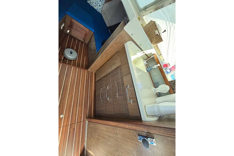 Slide: The Image of Interior of 1970 Bertram 31 Flybridge Cruiser with wood cabinetry and compact sink area. - 40