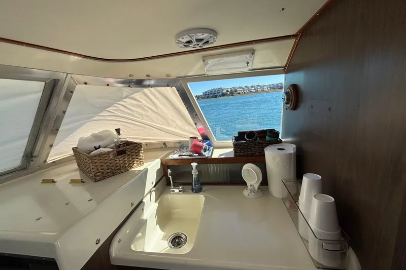 Slide: The Image of Interior of a 1970 Bertram 31 Flybridge Cruiser with sink and ocean view. - 42