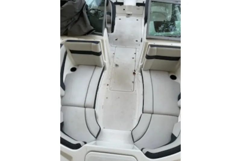Slide: The Image of 2015 Yamaha Boats SX210 interior with white seating and open deck layout. - 4