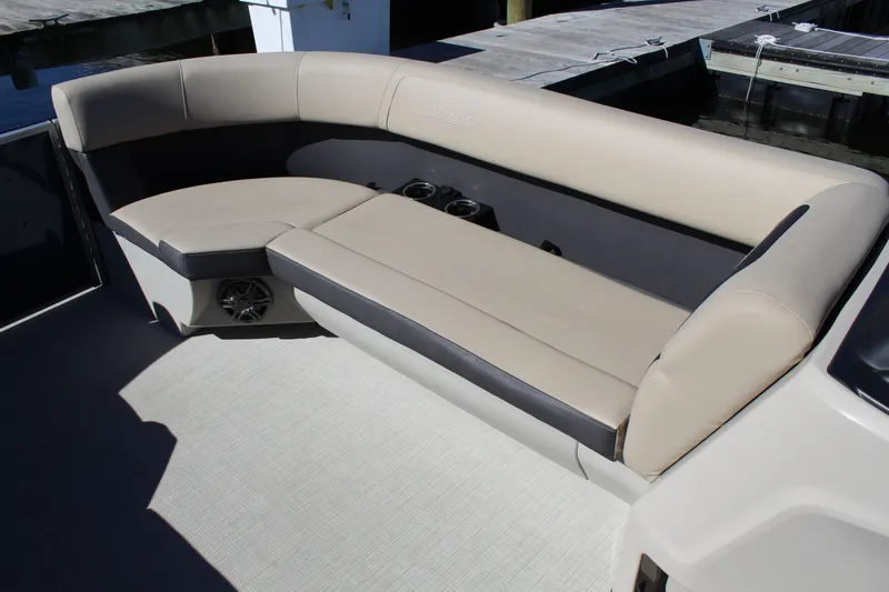 Slide: The Image of Luxurious seating on 2025 Harris Cruiser 230 boat, featuring beige and gray upholstery. - 12