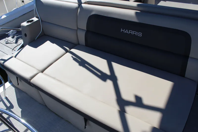 Slide: The Image of 2025 Harris Cruiser 230 boat seating with cup holder and sleek design. - 23