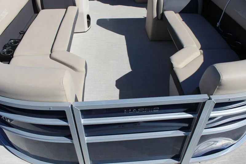 Slide: The Image of 2025 Harris Cruiser 230 interior with beige seating and cup holders. - 25