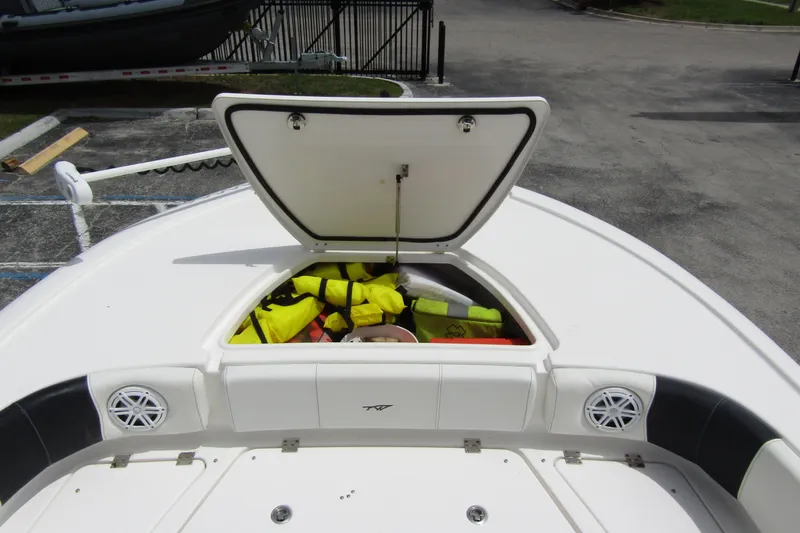 Slide: The Image of 2021 Tidewater 2700 Carolina Bay boat with open storage compartment and life jackets. - 11