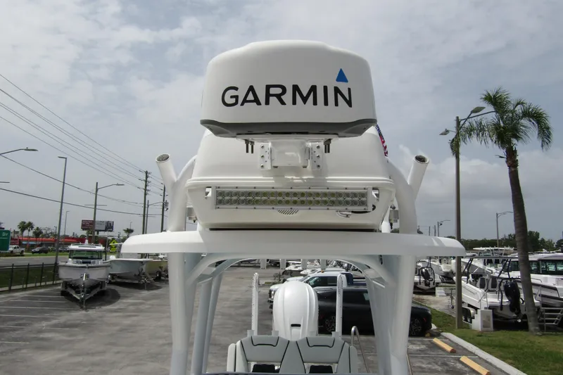 Slide: The Image of 2021 Tidewater 2700 Carolina Bay boat with Garmin radar, parked in a marina. - 16