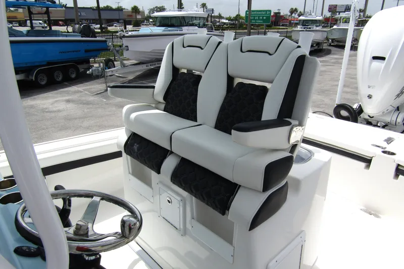 Slide: The Image of 2021 Tidewater 2700 Carolina Bay boat seats with armrests and steering wheel. - 20