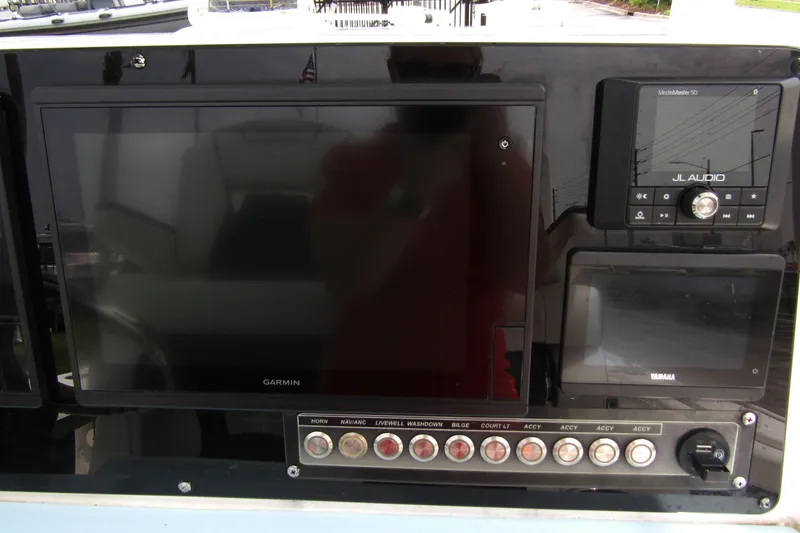 Slide: The Image of Dashboard of 2021 Tidewater 2700 Carolina Bay with Garmin and JL Audio systems. - 24