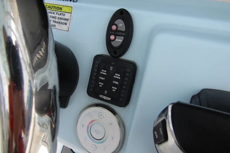 Slide: The Image of Control panel of 2021 Tidewater 2700 Carolina Bay boat with steering wheel and buttons. - 25