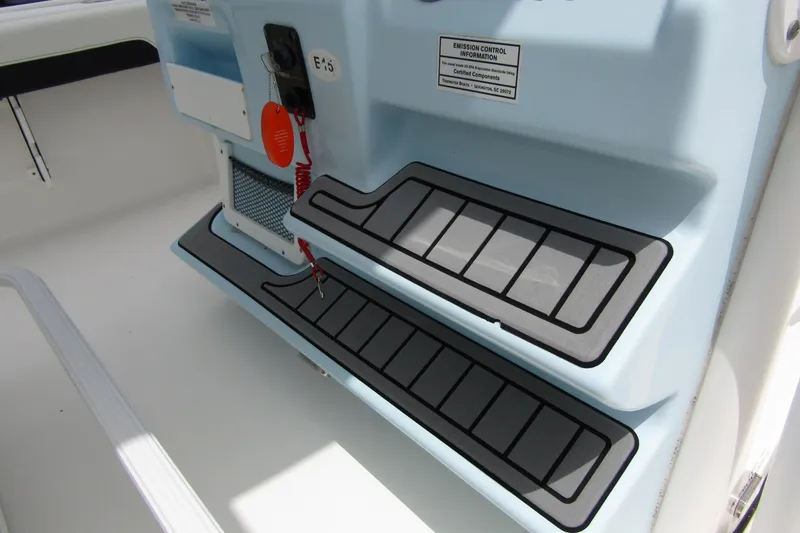Slide: The Image of 2021 Tidewater 2700 Carolina Bay boat interior with non-slip steps and control panel. - 27