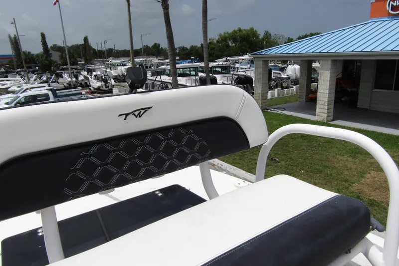 Slide: The Image of 2021 Tidewater 2700 Carolina Bay boat seat with logo, marina background. - 30