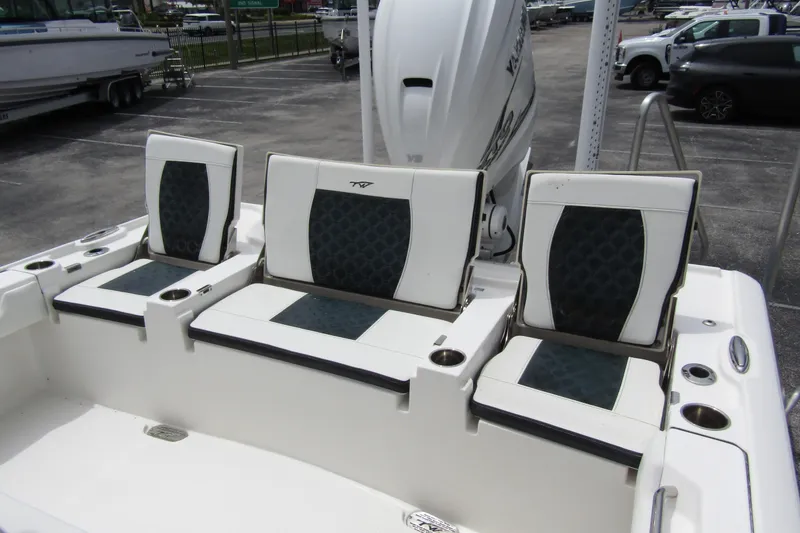 Slide: The Image of 2021 Tidewater 2700 Carolina Bay boat seating with cup holders and engine view. - 35