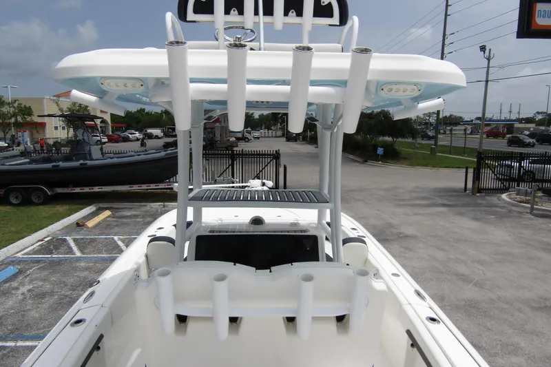 Slide: The Image of 2021 Tidewater 2700 Carolina Bay boat with T-top and rod holders in a parking lot. - 41