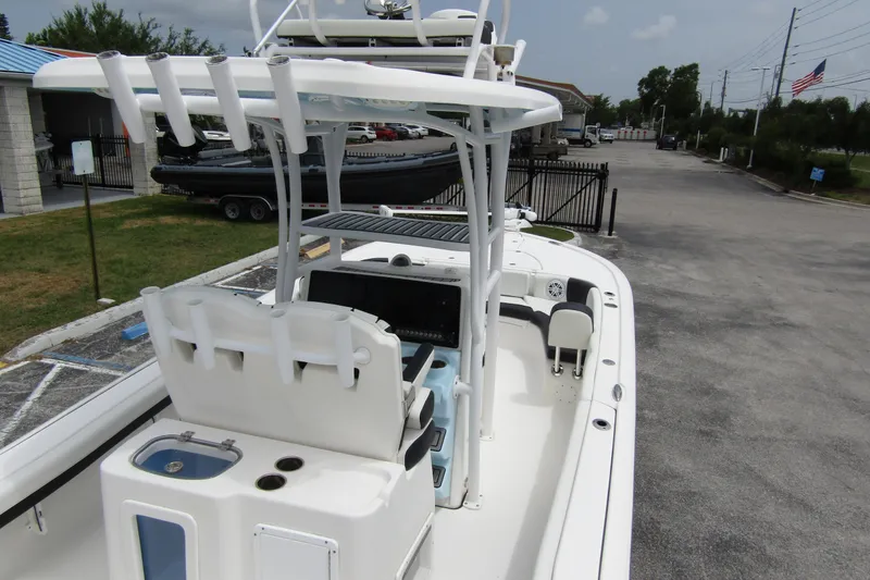 Slide: The Image of 2021 Tidewater 2700 Carolina Bay boat with T-top and seating, parked outdoors. - 42