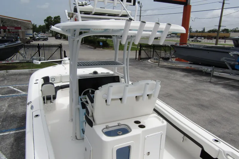Slide: The Image of 2021 Tidewater 2700 Carolina Bay boat with center console and rod holders in a parking lot. - 43
