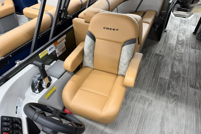 Slide: The Image of 2025 Crest Classic 220 boat interior with tan captain's chair and modern controls. - 7