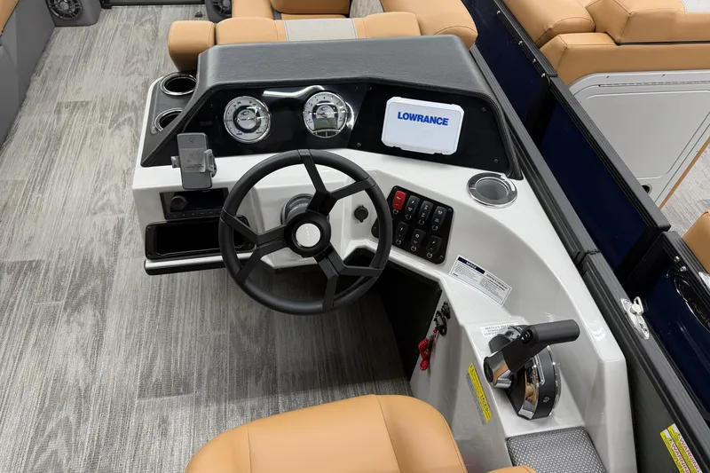 Slide: The Image of 2025 Crest Classic 220 boat dashboard with steering wheel and navigation controls. - 8