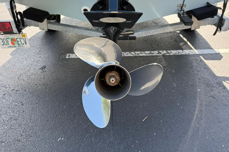 Slide: The Image of Propeller of 2025 Boston Whaler 170 Montauk boat on trailer, rear view. - 14