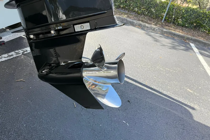 Slide: The Image of 2025 Boston Whaler 170 Montauk boat propeller in a parking lot. - 15