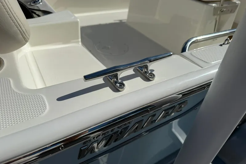 Slide: The Image of 2025 Boston Whaler 170 Montauk boat detail with cleat and embossed logo. - 18