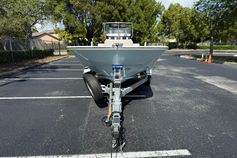 Slide: The Image of 2025 Boston Whaler 170 Montauk boat on trailer in parking lot. - 2