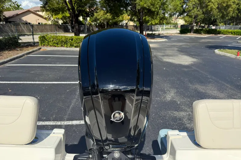 Slide: The Image of 2025 Boston Whaler 170 Montauk outboard motor in a parking lot setting. - 22