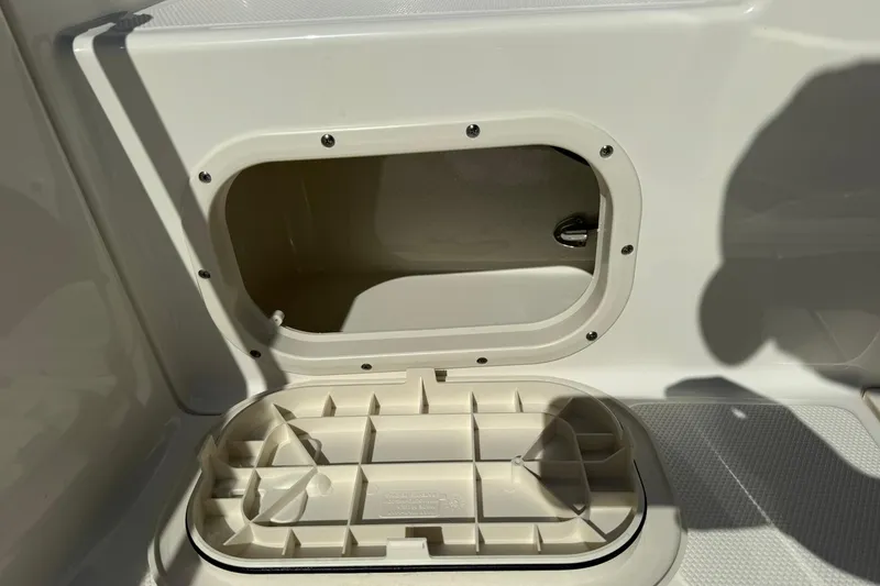 Slide: The Image of 2025 Boston Whaler 170 Montauk storage compartment detail, open hatch view. - 26