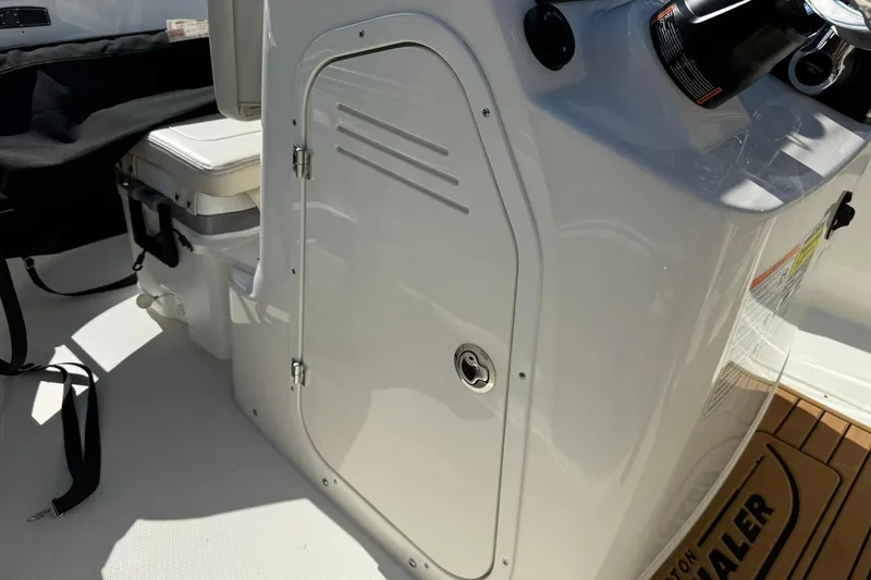 Slide: The Image of 2025 Boston Whaler 170 Montauk boat console with storage compartment and seating. - 31