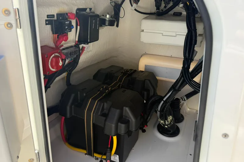 Slide: The Image of 2025 Boston Whaler 170 Montauk battery compartment with wiring and electrical components. - 33