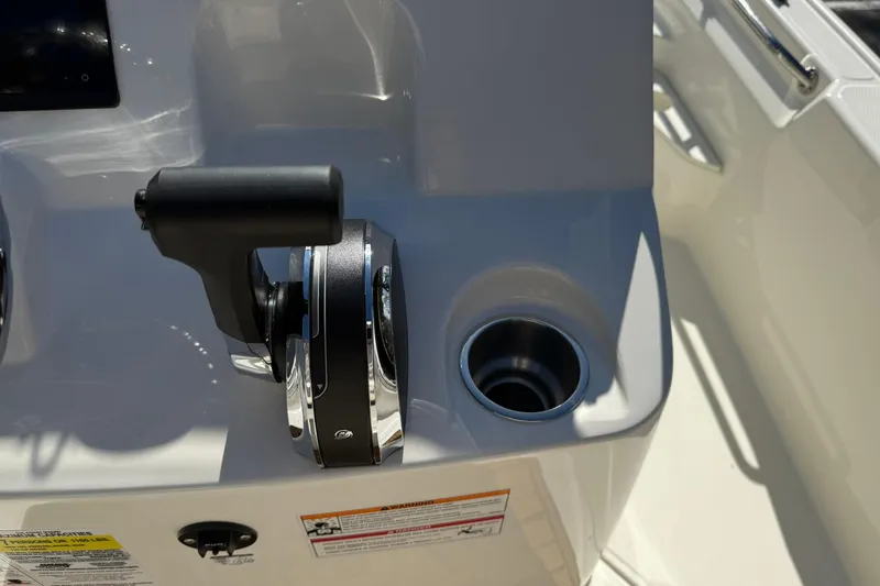 Slide: The Image of 2025 Boston Whaler 170 Montauk boat throttle control and cup holder detail. - 38