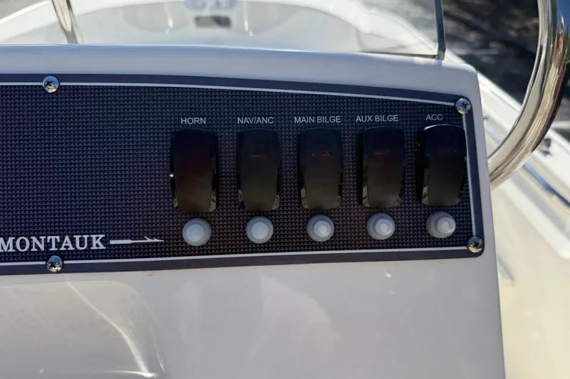 Slide: The Image of Control panel of 2025 Boston Whaler 170 Montauk boat with labeled switches. - 39