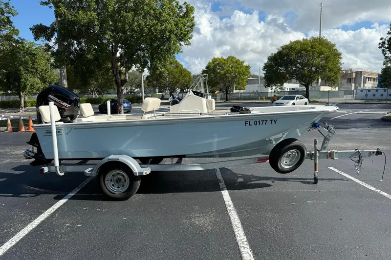 Slide: The Image of 2025 Boston Whaler 170 Montauk boat on trailer in parking lot. - 4
