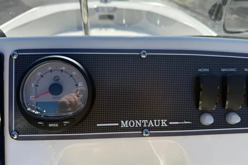 Slide: The Image of 2025 Boston Whaler 170 Montauk dashboard with RPM gauge and control switches. - 40
