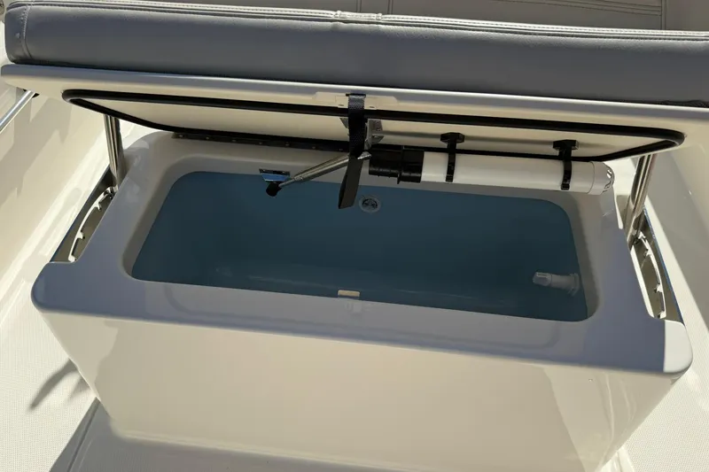 Slide: The Image of 2025 Boston Whaler 170 Montauk livewell with open lid, showcasing interior features. - 42