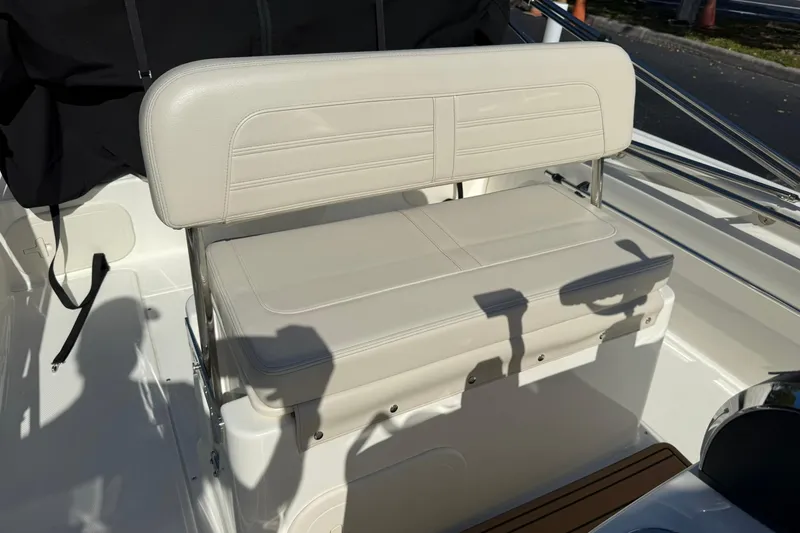 Slide: The Image of 2025 Boston Whaler 170 Montauk boat seat, beige upholstery, sleek design, outdoor setting. - 45