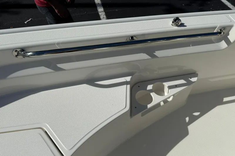 Slide: The Image of 2025 Boston Whaler 170 Montauk boat interior with stainless steel rail and cup holders. - 49